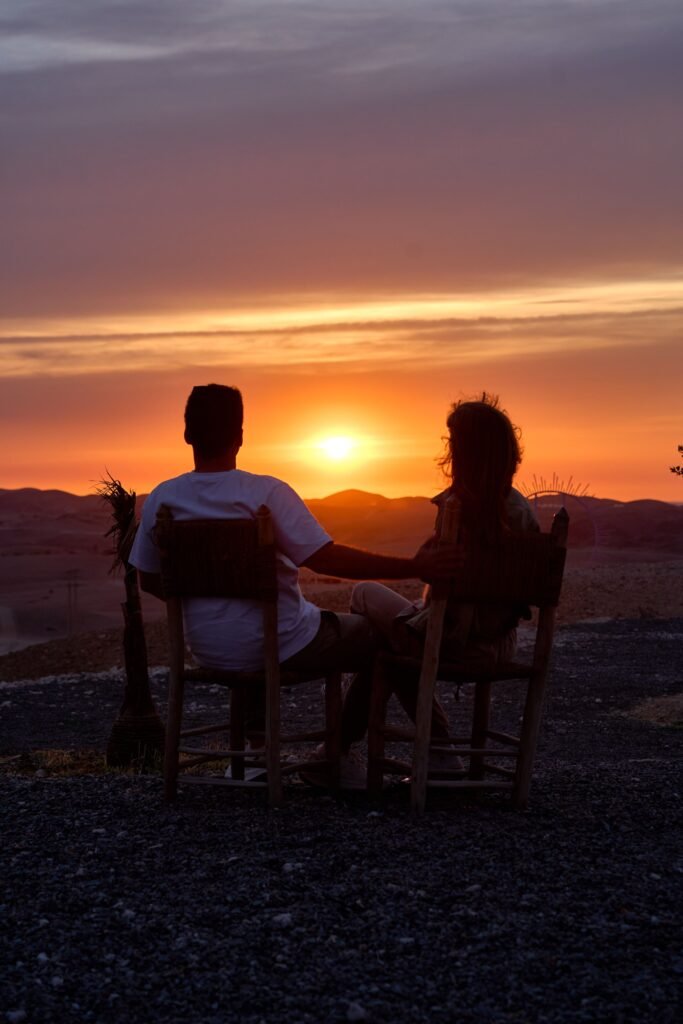 couple watching the sunset in the Moroccan desert